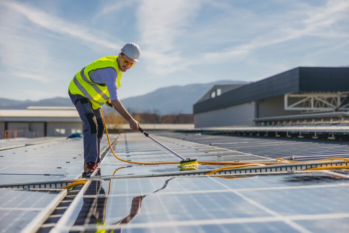 Bild zeigt die Reinigung eines Solarmoduls durch Fachkraft